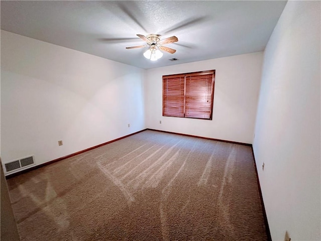 unfurnished room with ceiling fan, carpet, visible vents, and baseboards