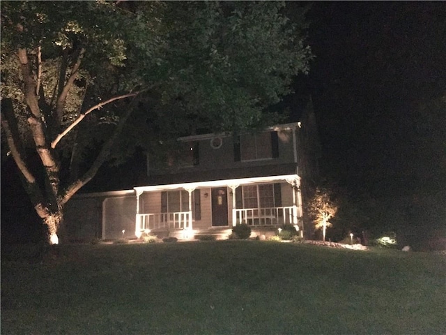 view of front of property with covered porch and a front lawn