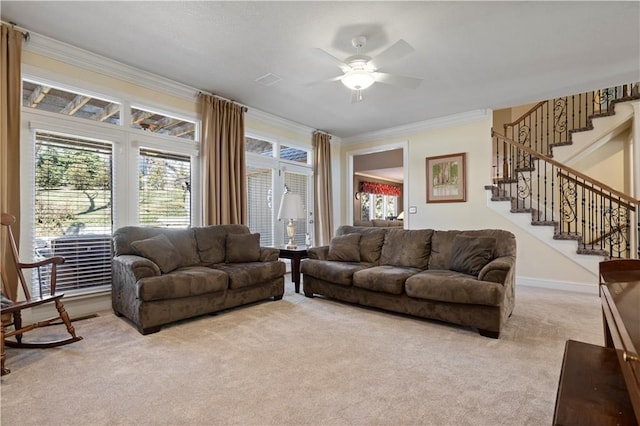 living area with baseboards, a ceiling fan, ornamental molding, stairs, and carpet floors