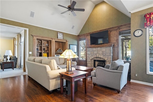 living room featuring plenty of natural light, a fireplace, high vaulted ceiling, and wood finished floors