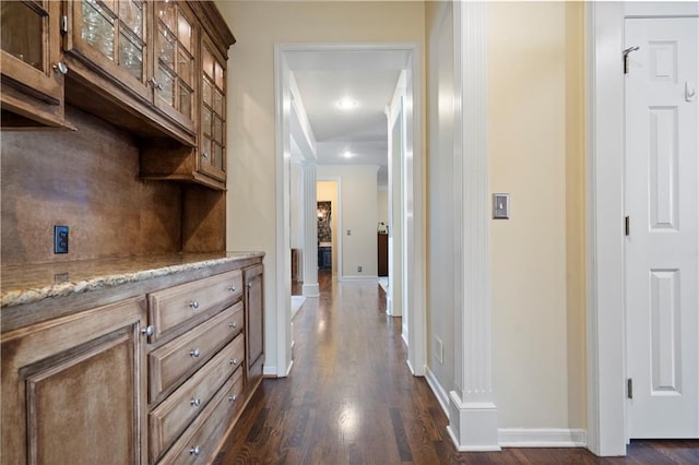 hall featuring dark wood finished floors and baseboards