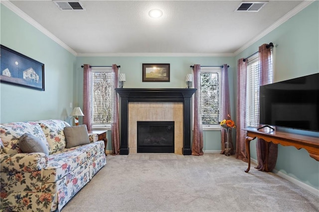 carpeted living area with ornamental molding, plenty of natural light, and visible vents