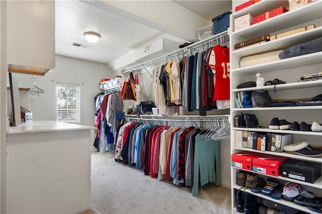 walk in closet featuring carpet flooring and visible vents