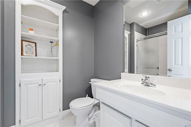 full bath with toilet, tile patterned floors, vanity, and a shower with shower door