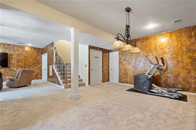 exercise room with carpet, visible vents, and baseboards