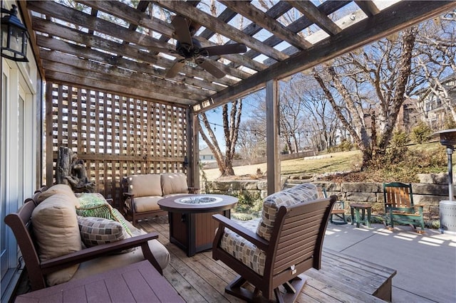 wooden deck with an outdoor living space with a fire pit, a ceiling fan, and a pergola