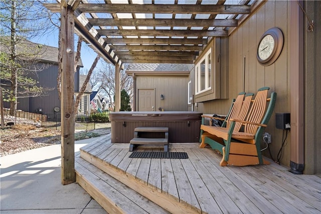 wooden deck with a hot tub