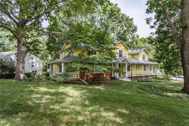 country-style home with covered porch and a front yard