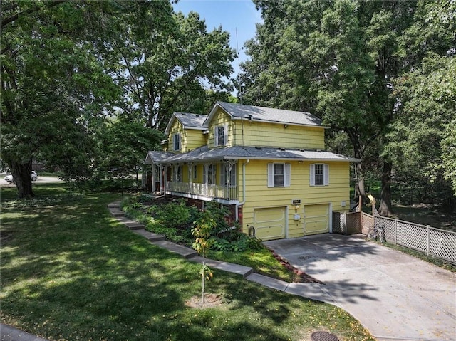 view of side of property featuring concrete driveway, fence, a garage, and a lawn