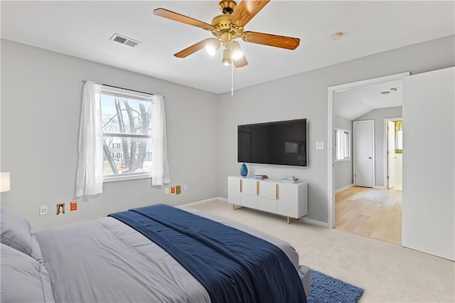 bedroom with visible vents, light carpet, baseboards, and a ceiling fan