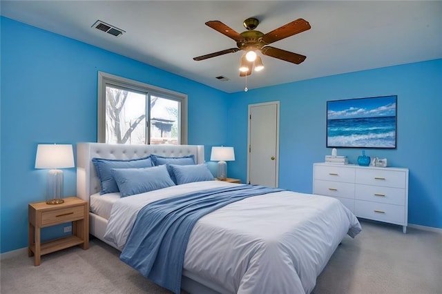 bedroom with visible vents, baseboards, light colored carpet, and ceiling fan