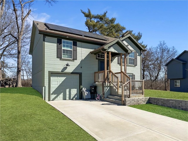 split foyer home featuring solar panels, a front lawn, an attached garage, and driveway