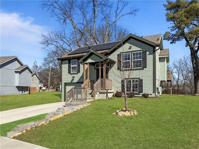 view of front of property featuring a garage, roof mounted solar panels, concrete driveway, and a front yard