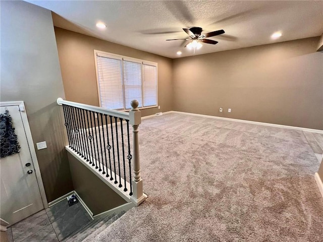 unfurnished room with a textured ceiling, baseboards, carpet flooring, and recessed lighting