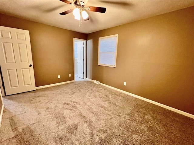 unfurnished bedroom with carpet, a ceiling fan, and baseboards