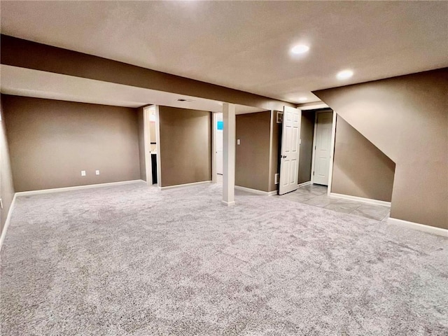 finished basement with recessed lighting, light colored carpet, and baseboards