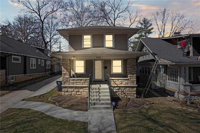 view of front of home featuring stone siding and a porch