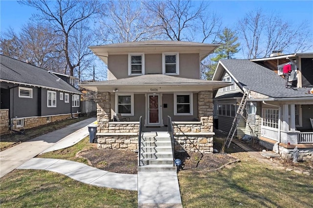 traditional style home with stone siding, stucco siding, and a porch