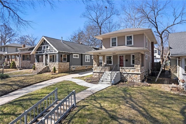 traditional style home with a porch, a front lawn, stone siding, and stucco siding