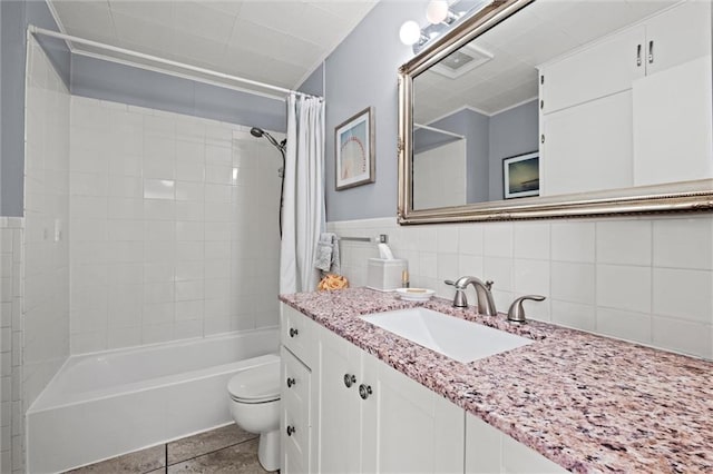 bathroom featuring toilet, shower / bath combo, tile walls, tile patterned flooring, and vanity