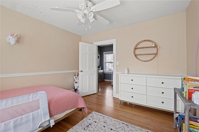 bedroom with wood finished floors and a ceiling fan