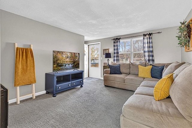 carpeted living room with a textured ceiling and baseboards