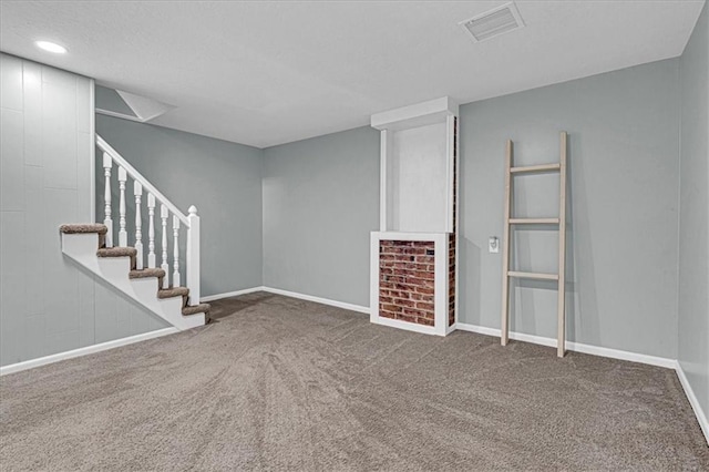 unfurnished living room featuring recessed lighting, carpet floors, visible vents, baseboards, and stairway