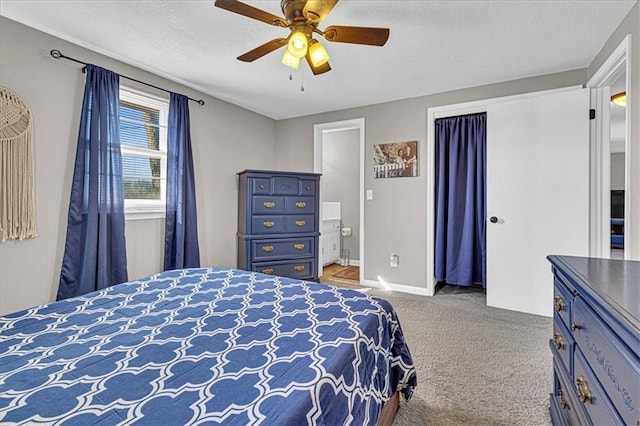 bedroom with a textured ceiling, ceiling fan, carpet flooring, and baseboards