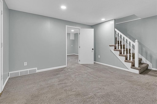 interior space featuring carpet floors, stairway, baseboards, and visible vents