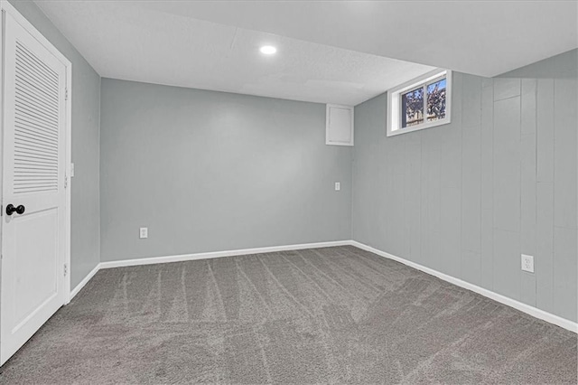 below grade area featuring carpet and baseboards