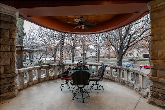 view of patio / terrace featuring ceiling fan, a residential view, and outdoor dining space