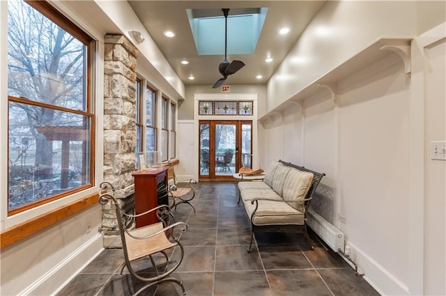 sitting room with radiator heating unit, baseboards, french doors, and recessed lighting