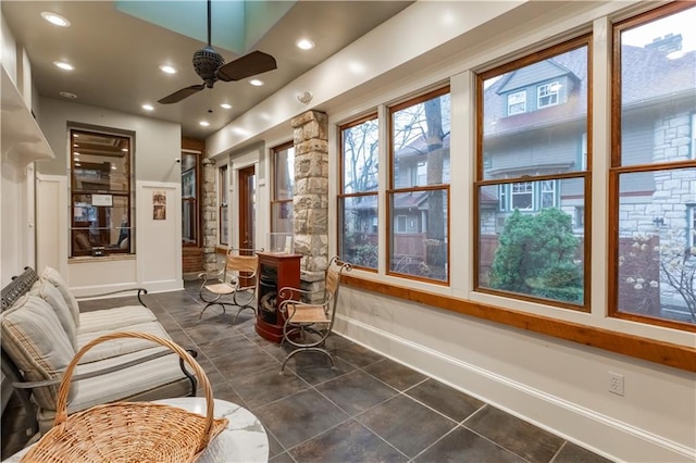 sunroom featuring ceiling fan