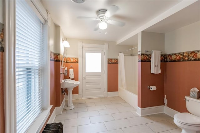 full bath with toilet, shower / bathtub combination with curtain, a ceiling fan, and tile patterned floors