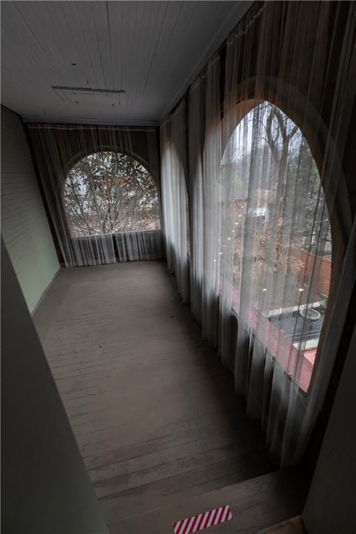 interior space with wooden ceiling and wood finished floors