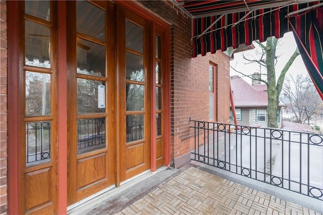 doorway to property with brick siding