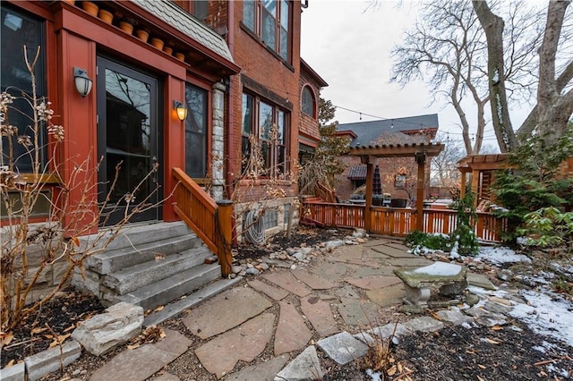 entrance to property featuring a patio area