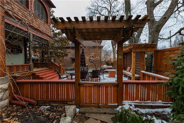 wooden terrace with outdoor dining space and a pergola