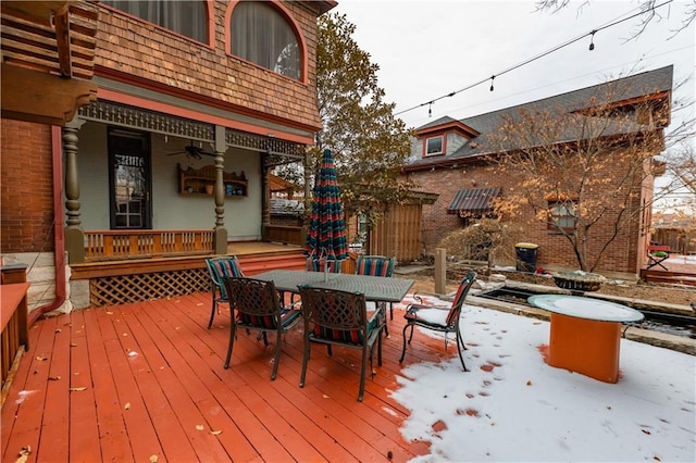 wooden deck featuring ceiling fan and outdoor dining area