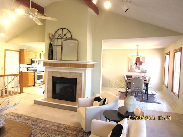 living area featuring a fireplace, high vaulted ceiling, and track lighting