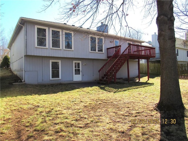 back of property with fence, stairs, a yard, a wooden deck, and a chimney