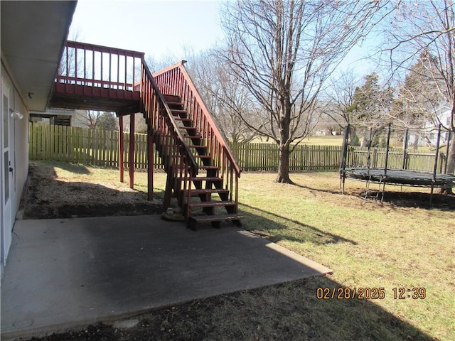 view of yard featuring stairway, a trampoline, a patio area, and a fenced backyard