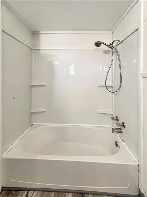 bathroom featuring bathing tub / shower combination and wood finished floors