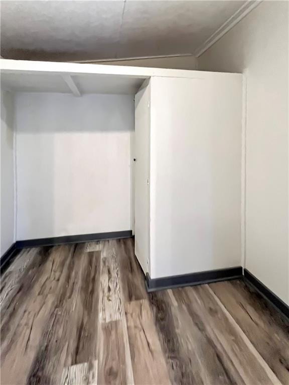 unfurnished room featuring baseboards and wood finished floors