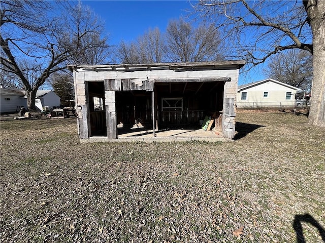 view of outdoor structure featuring an outbuilding and fence