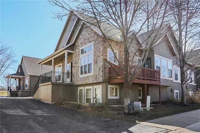 view of property exterior featuring stone siding and stucco siding