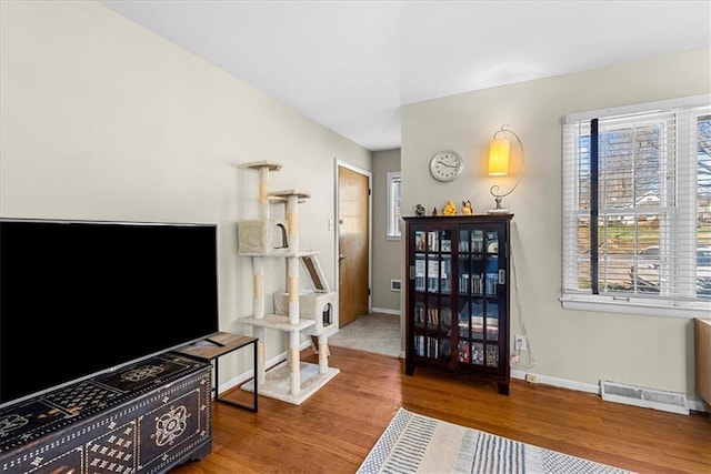interior space featuring visible vents, wood finished floors, and baseboards