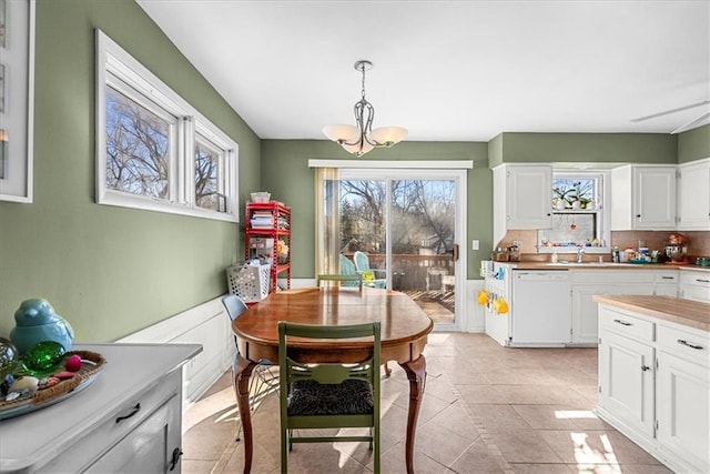 dining room with a chandelier and light tile patterned floors