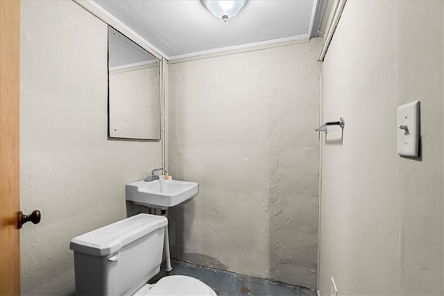 bathroom featuring toilet and unfinished concrete floors