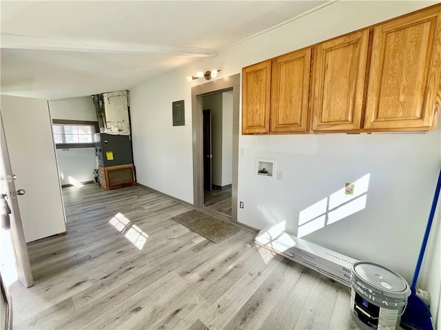 laundry area with hookup for a washing machine, electric panel, cabinet space, and light wood-style floors